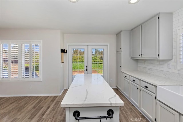 1825 Duncan Way, Corona, CA 92881 - kitchen featuring french doors, healthy amount of natural light, light wood-type flooring, and tasteful backsplash