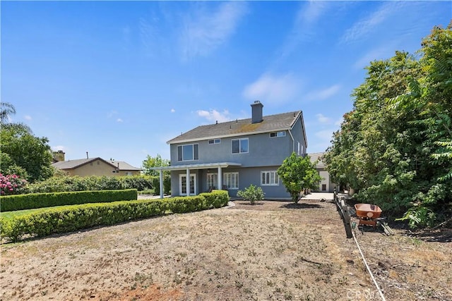 1825 Duncan Way, Corona, CA 92881 - rear view of house with a chimney and stucco siding