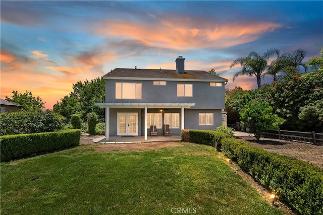 1825 Duncan Way, Corona, CA 92881 - back of property at dusk featuring french doors, stucco siding, a patio, and a chimney