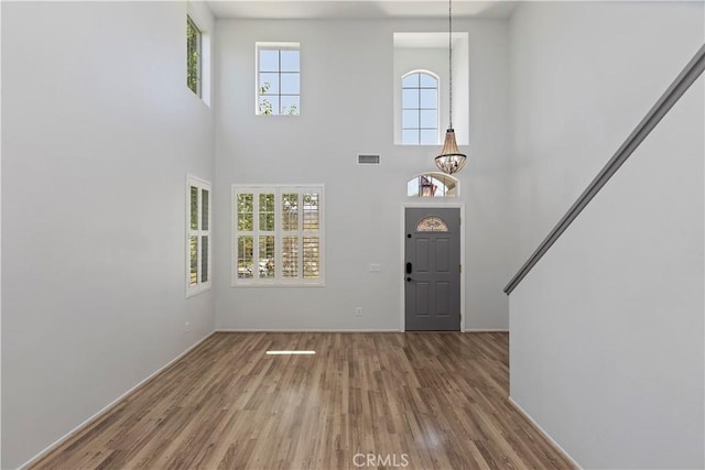 1825 Duncan Way, Corona, CA 92881 - entrance foyer featuring wood finished floors, a towering ceiling, a chandelier, and baseboards