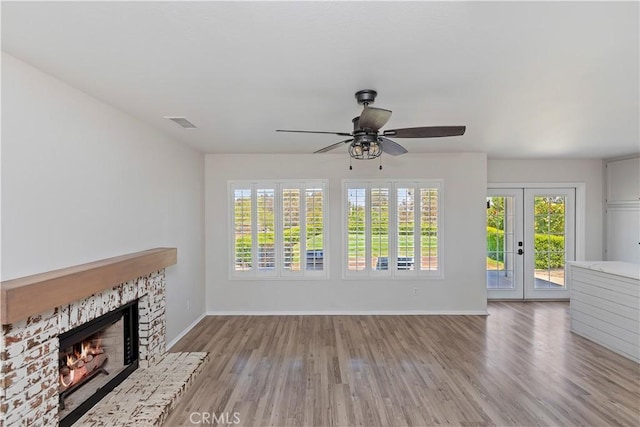 1825 Duncan Way, Corona, CA 92881 - unfurnished living room with ceiling fan, baseboards, a warm lit fireplace, and healthy amount of natural light
