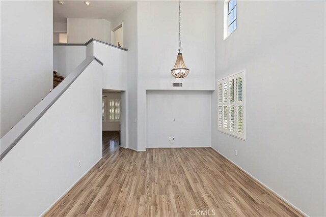 1825 Duncan Way, Corona, CA 92881 - foyer with wood finished floors, a towering ceiling, stairway, a chandelier, and baseboards