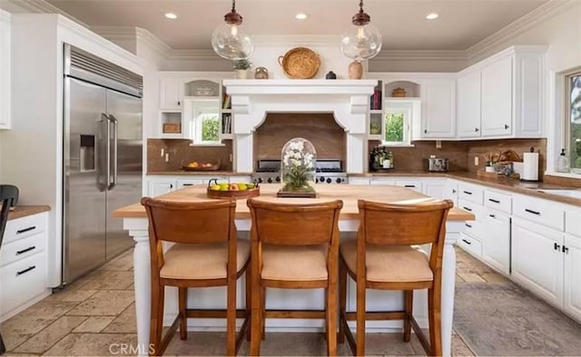 411 Snug Harbor Rd, Newport Beach, CA 92663 - kitchen with open shelves, stainless steel built in fridge, white cabinetry, plenty of natural light, and recessed lighting