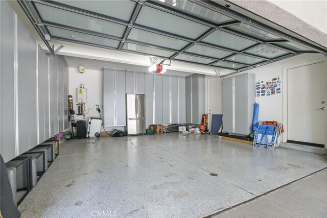 1639 Bridgewater Way, Costa Mesa, CA 92627 - garage with freestanding refrigerator and a garage door opener