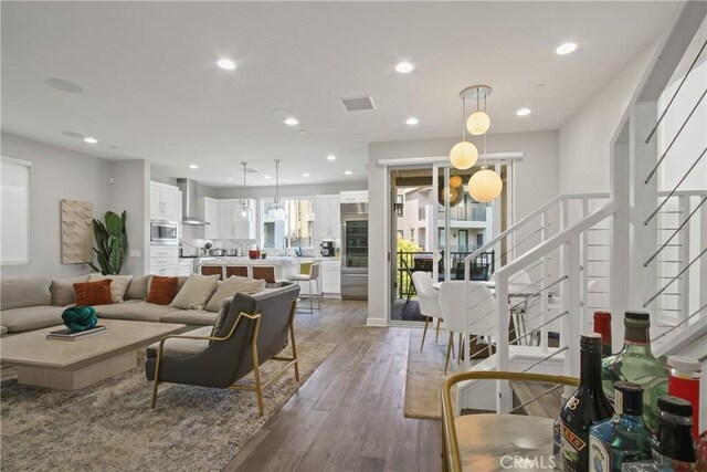 1639 Bridgewater Way, Costa Mesa, CA 92627 - living area with stairway, hardwood / wood-style flooring, and recessed lighting