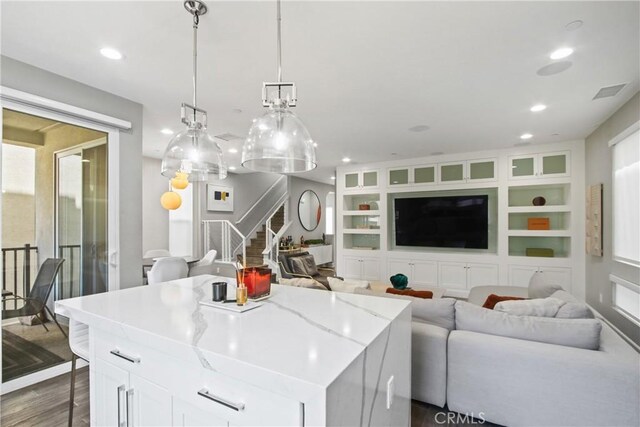 1639 Bridgewater Way, Costa Mesa, CA 92627 - kitchen with dark wood finished floors, open floor plan, white cabinets, recessed lighting, and a center island