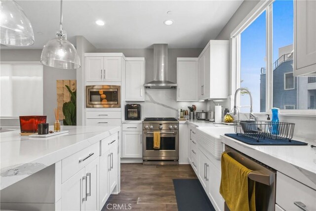 1639 Bridgewater Way, Costa Mesa, CA 92627 - kitchen with wall chimney exhaust hood, appliances with stainless steel finishes, light countertops, white cabinetry, and dark wood-style floors