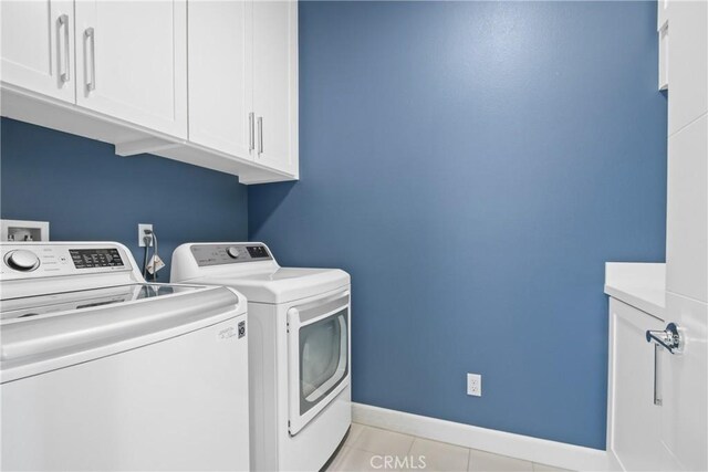 1639 Bridgewater Way, Costa Mesa, CA 92627 - washroom with washing machine and dryer, cabinet space, baseboards, and light tile patterned flooring