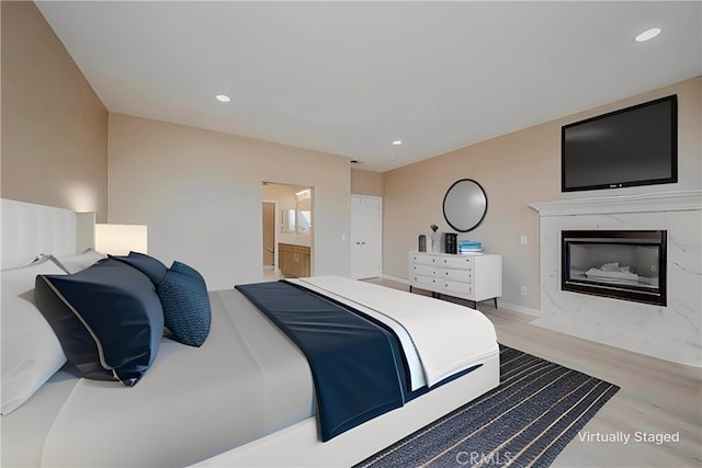 5338 S Chariton Ave, Ladera Heights, CA 90056 - bedroom featuring wood finished floors, a premium fireplace, recessed lighting, and connected bathroom