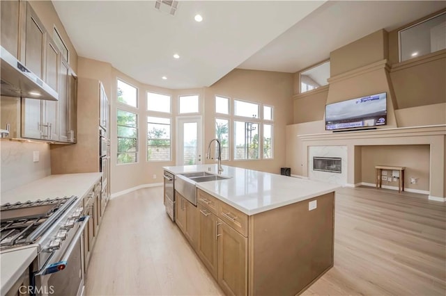 5338 S Chariton Ave, Ladera Heights, CA 90056 - kitchen with a sink, light wood-style floors, under cabinet range hood, baseboards, and a kitchen island with sink