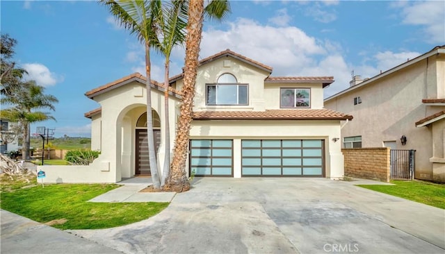 5338 S Chariton Ave, Ladera Heights, CA 90056 - mediterranean / spanish-style home with a garage, a tiled roof, stucco siding, and driveway