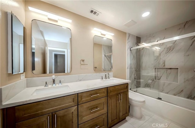 5338 S Chariton Ave, Ladera Heights, CA 90056 - full bath featuring double vanity, toilet, enclosed tub / shower combo, and tile patterned flooring