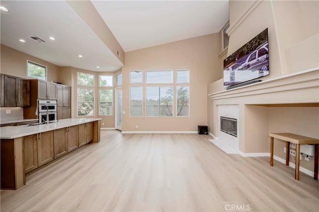 5338 S Chariton Ave, Ladera Heights, CA 90056 - kitchen featuring light countertops, stainless steel double oven, light wood-style floors, open floor plan, and recessed lighting