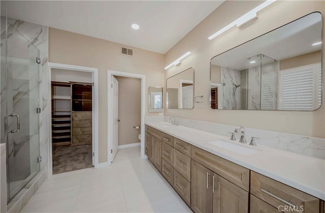 5338 S Chariton Ave, Ladera Heights, CA 90056 - full bath featuring a marble finish shower, double vanity, toilet, tile patterned flooring, and recessed lighting