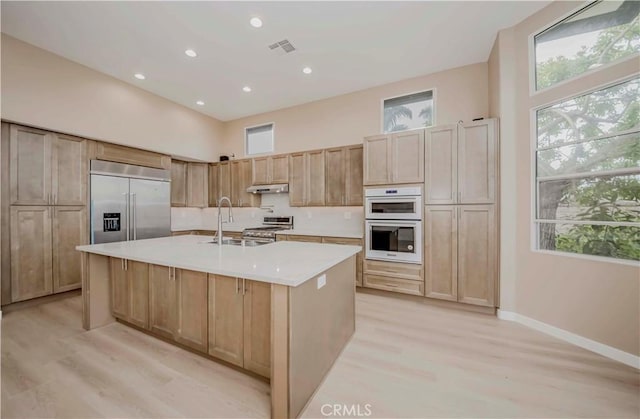 5338 S Chariton Ave, Ladera Heights, CA 90056 - kitchen with stainless steel appliances, healthy amount of natural light, light countertops, light wood-style flooring, and recessed lighting