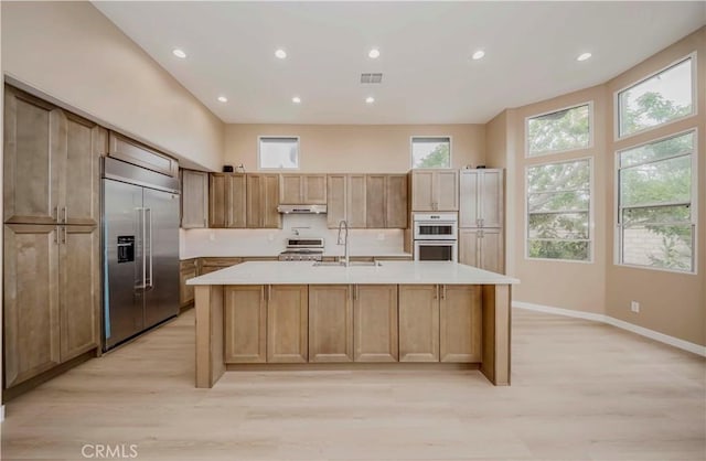 5338 S Chariton Ave, Ladera Heights, CA 90056 - kitchen with built in fridge, stove, a sink, under cabinet range hood, and light wood finished floors