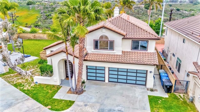 5338 S Chariton Ave, Ladera Heights, CA 90056 - mediterranean / spanish house with stucco siding, a tiled roof, concrete driveway, and an attached garage