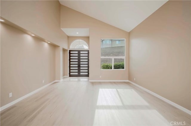 5338 S Chariton Ave, Ladera Heights, CA 90056 - spare room with wood finished floors, baseboards, and high vaulted ceiling