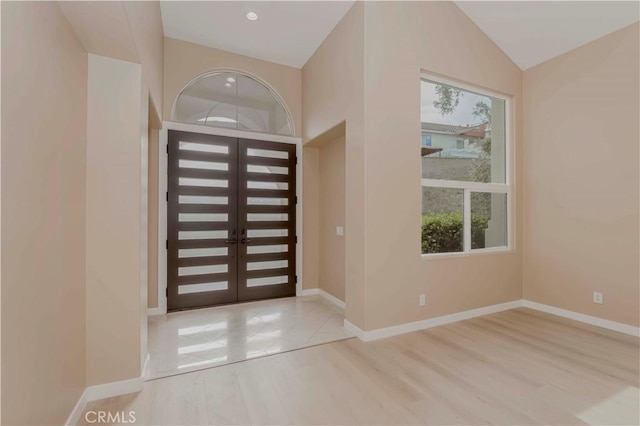 5338 S Chariton Ave, Ladera Heights, CA 90056 - foyer featuring wood finished floors, baseboards, and vaulted ceiling