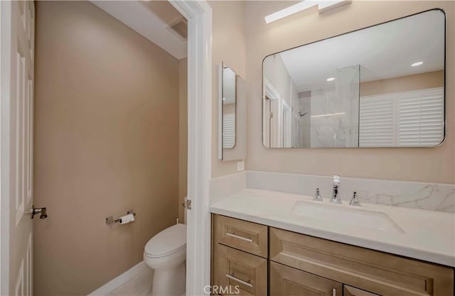 5338 S Chariton Ave, Ladera Heights, CA 90056 - bathroom featuring vanity, toilet, a shower, and baseboards