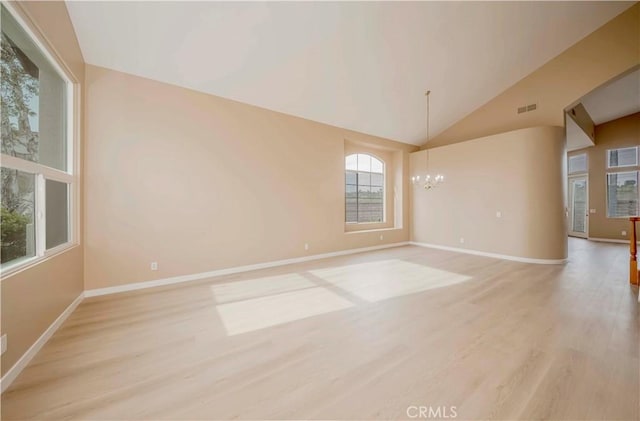 5338 S Chariton Ave, Ladera Heights, CA 90056 - empty room with a chandelier, light wood-style floors, baseboards, and vaulted ceiling