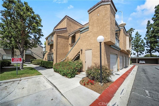 3501 W Greentree Cir Unit F, Anaheim, CA 92804 - view of property featuring stairway and community garages