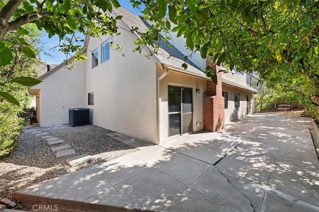 770 Libby Dr, Riverside, CA 92507 - rear view of house featuring a patio, stucco siding, central AC, and roof with shingles