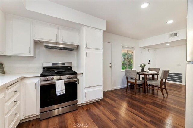 770 Libby Dr, Riverside, CA 92507 - kitchen featuring gas range, under cabinet range hood, light countertops, dark wood-style flooring, and white cabinetry