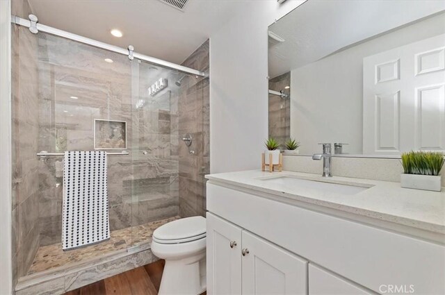770 Libby Dr, Riverside, CA 92507 - full bath with a stall shower, vanity, toilet, wood finished floors, and recessed lighting