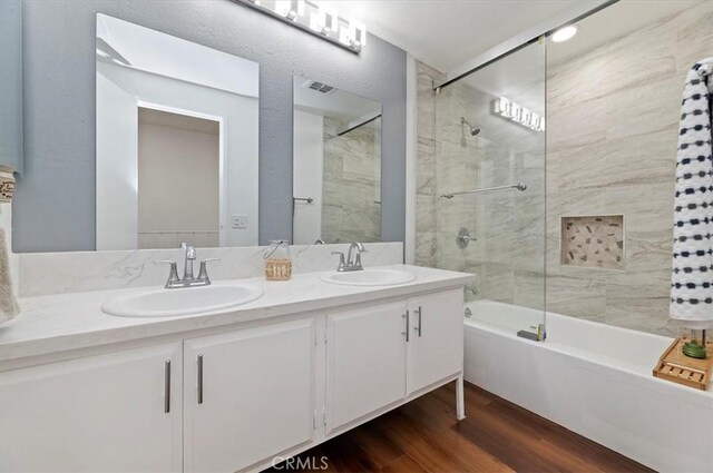 770 Libby Dr, Riverside, CA 92507 - full bathroom featuring bathing tub / shower combination, double vanity, and wood finished floors