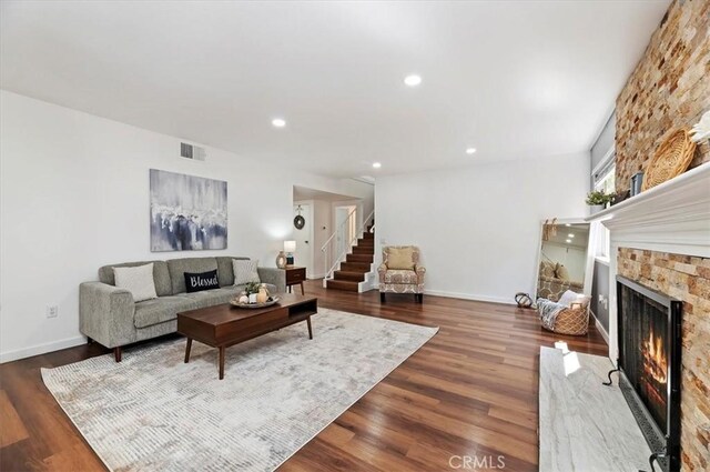 770 Libby Dr, Riverside, CA 92507 - living room with a warm lit fireplace, wood finished floors, stairs, recessed lighting, and baseboards