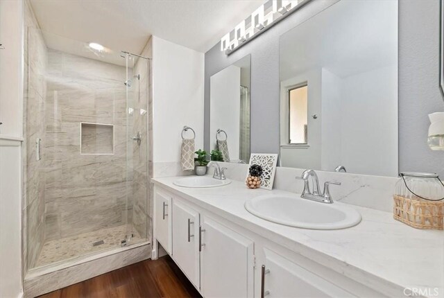 770 Libby Dr, Riverside, CA 92507 - bathroom with double vanity, a stall shower, and wood finished floors
