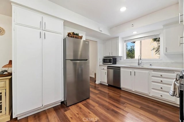 770 Libby Dr, Riverside, CA 92507 - kitchen featuring appliances with stainless steel finishes, a sink, light countertops, dark wood-style flooring, and white cabinets