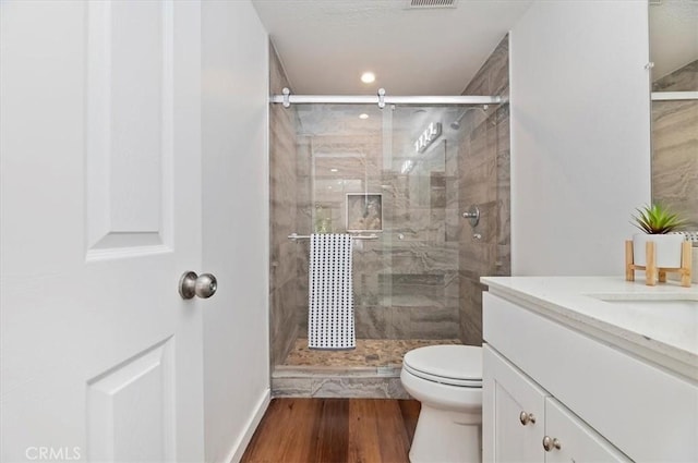 770 Libby Dr, Riverside, CA 92507 - full bathroom with toilet, vanity, a stall shower, wood finished floors, and recessed lighting