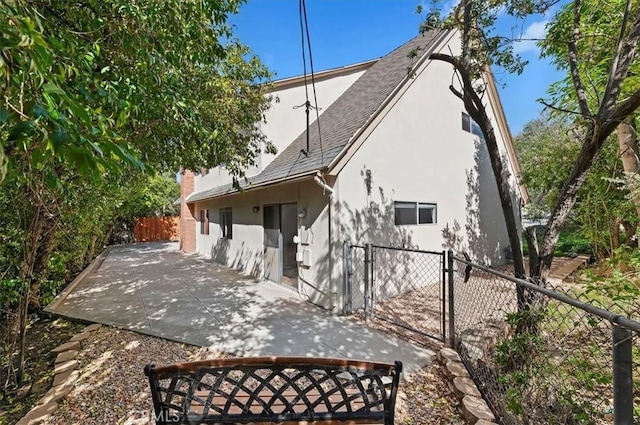 770 Libby Dr, Riverside, CA 92507 - back of property with stucco siding, a gate, a fenced backyard, roof with shingles, and a patio area