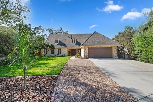 770 Libby Dr, Riverside, CA 92507 - view of front of property featuring an attached garage, concrete driveway, a front yard, and brick siding