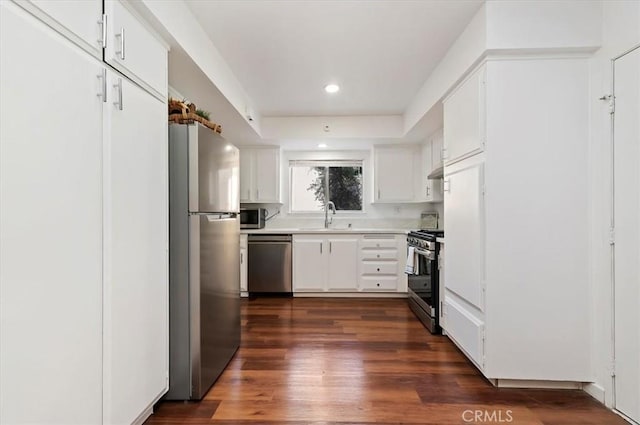 770 Libby Dr, Riverside, CA 92507 - kitchen featuring appliances with stainless steel finishes, a sink, light countertops, dark wood finished floors, and white cabinets
