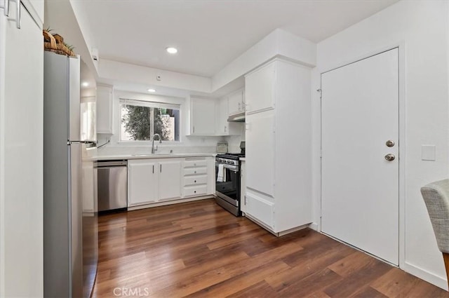 770 Libby Dr, Riverside, CA 92507 - kitchen featuring appliances with stainless steel finishes, a sink, light countertops, dark wood-type flooring, and white cabinets