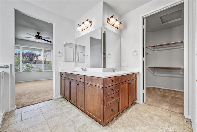 19118 Opal Ct, Apple Valley, CA 92308 - bathroom with double vanity, baseboards, a spacious closet, tile patterned floors, and ceiling fan