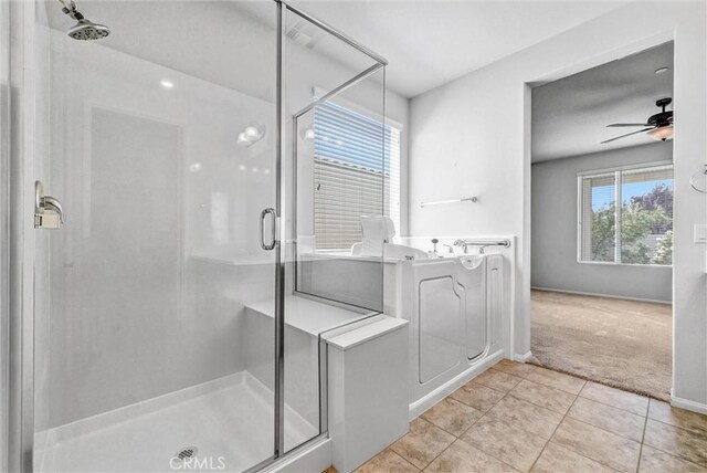 19118 Opal Ct, Apple Valley, CA 92308 - bathroom featuring a shower stall, tile patterned flooring, ceiling fan, and a bath