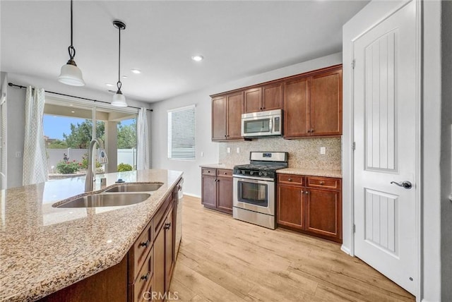 19118 Opal Ct, Apple Valley, CA 92308 - kitchen with appliances with stainless steel finishes, a sink, light wood-style floors, recessed lighting, and light stone countertops