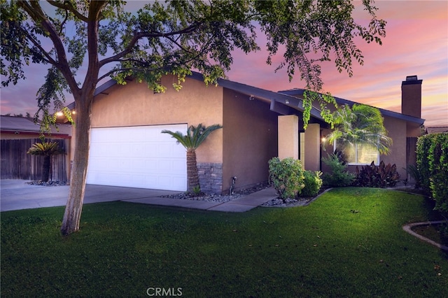 6300 Ringwood St, Bakersfield, CA 93313 - view of front of home with an attached garage, stucco siding, a front lawn, and driveway