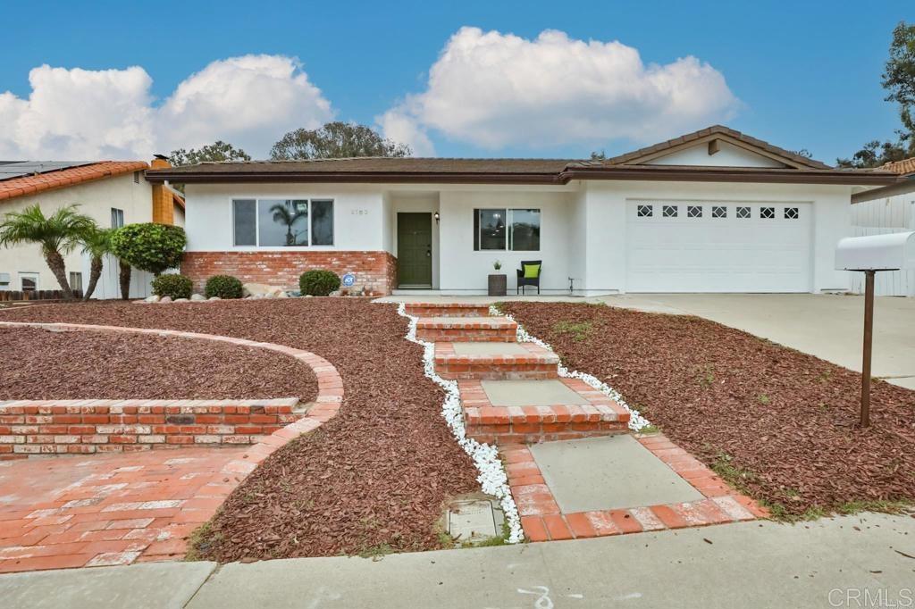 4103 Corral Canyon Rd, Bonita, CA 91902 - ranch-style house with brick siding, an attached garage, driveway, and stucco siding