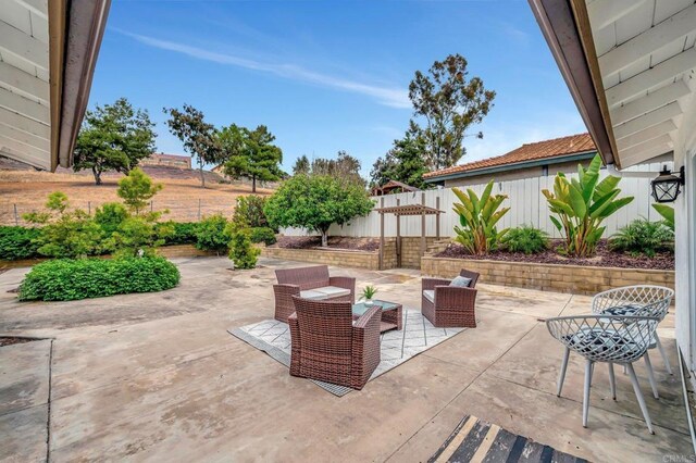 4103 Corral Canyon Rd, Bonita, CA 91902 - fenced backyard featuring a patio area and an outdoor hangout area