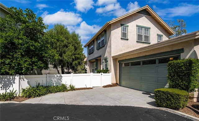 167 Iris Ln, Brea, CA 92821 - view of front of house with concrete driveway, stucco siding, and an attached garage