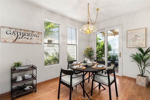 167 Iris Ln, Brea, CA 92821 - dining room featuring a chandelier, light wood-style flooring, and baseboards