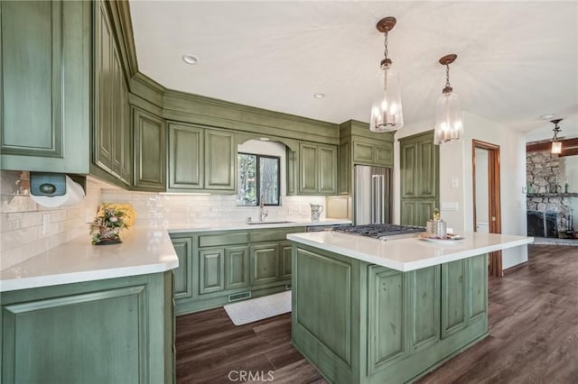 551 Raccoon Ct, Lake Arrowhead, CA 92352 - kitchen featuring green cabinetry, appliances with stainless steel finishes, light countertops, and backsplash
