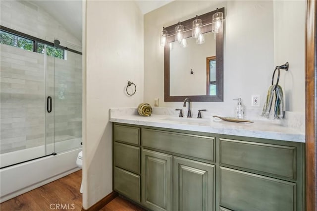 551 Raccoon Ct, Lake Arrowhead, CA 92352 - bathroom with toilet, vanity, wood finished floors, enclosed tub / shower combo, and lofted ceiling