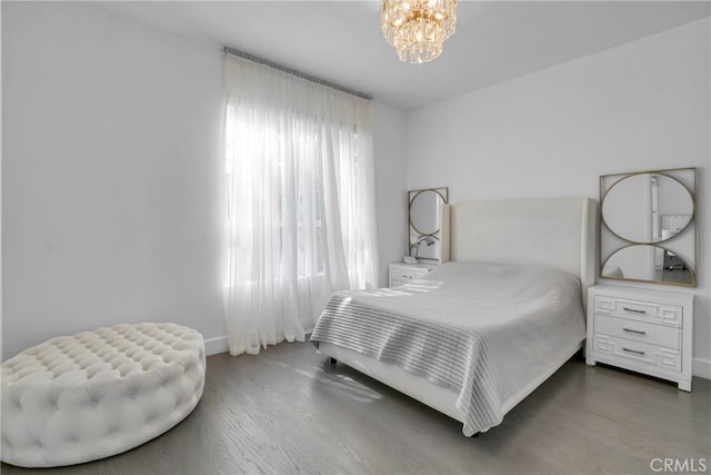 14347 Albers St Unit 207, Sherman Oaks, CA 91401 - bedroom featuring a chandelier, baseboards, and wood finished floors