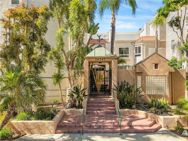 14347 Albers St Unit 207, Sherman Oaks, CA 91401 - view of front of home with stucco siding, a gate, and a tiled roof